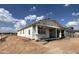 Newly built home with wrapped exterior, showcasing a modern design in a neighborhood under construction at 15794 W Cheryl Dr, Waddell, AZ 85355