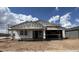 New home with scaffolding in the building phase, presenting a modern and spacious design at 15794 W Cheryl Dr, Waddell, AZ 85355