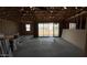 View of a large great room under construction with sliding glass doors to the backyard at 15794 W Cheryl Dr, Waddell, AZ 85355