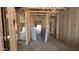 The unfinished interior showcases exposed wooden framing, revealing the home's structural elements at 15794 W Cheryl Dr, Waddell, AZ 85355