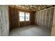 A framed room with visible insulation presents a cozy atmosphere, awaiting finishing touches and personalization at 15794 W Cheryl Dr, Waddell, AZ 85355