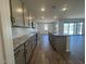 Open-concept kitchen featuring granite countertops, stainless steel appliances, and access to the backyard at 15794 W Cheryl Dr, Waddell, AZ 85355