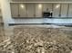 Close up on granite counter top with modern cabinetry and stainless steel microwave in the kitchen at 15794 W Cheryl Dr, Waddell, AZ 85355