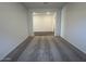 Bright living room featuring plush carpeting, neutral walls, and an open doorway leading to additional living spaces at 15794 W Cheryl Dr, Waddell, AZ 85355