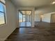 Bright living room with sliding glass doors to the patio and wood-look tile flooring at 15794 W Cheryl Dr, Waddell, AZ 85355