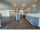 Open concept living area with stylish flooring and seamless flow into the kitchen at 15794 W Cheryl Dr, Waddell, AZ 85355
