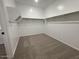 Spacious walk-in closet featuring carpet floors and shelving for optimal storage at 15794 W Cheryl Dr, Waddell, AZ 85355