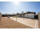 Spacious backyard featuring a sports court, gravel landscaping, and comfortable outdoor seating area at 1609 W Yukon Dr, Phoenix, AZ 85027