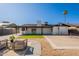 Open backyard features a covered patio, tennis court, and outdoor seating, creating a versatile entertaining space at 1609 W Yukon Dr, Phoenix, AZ 85027