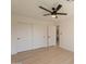 Bedroom with a ceiling fan and a spacious closet with white doors, offering ample storage at 1609 W Yukon Dr, Phoenix, AZ 85027