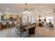 Open dining area with modern lighting, a stylish table setting, and seamless flow into the living room and kitchen at 1609 W Yukon Dr, Phoenix, AZ 85027