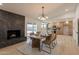 Open concept dining room featuring a stone fireplace and modern lighting and access to kitchen at 1609 W Yukon Dr, Phoenix, AZ 85027