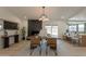 Open dining room showcasing a modern fireplace, stylish chandelier, and seamless access to the outdoor area at 1609 W Yukon Dr, Phoenix, AZ 85027