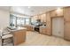 Modern kitchen featuring wood cabinetry, stainless steel appliances, and a stylish breakfast bar at 1609 W Yukon Dr, Phoenix, AZ 85027