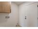 Practical laundry room with a cabinet and hookups for washer and dryer at 1609 W Yukon Dr, Phoenix, AZ 85027