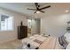 Bright main bedroom with wood floors, a ceiling fan and barn door leading to the en suite bathroom at 1609 W Yukon Dr, Phoenix, AZ 85027