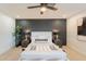 Modern main bedroom showcasing a decorative throw blanket, wood nightstands and ceiling fan at 1609 W Yukon Dr, Phoenix, AZ 85027