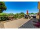 Paver patio backyard with an outdoor kitchen, bar seating, stone decor, and desert landscaping at 16538 E Westwind Ct # 51, Fountain Hills, AZ 85268