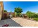 Paver patio backyard featuring a decorative stone wall and lush landscaping at 16538 E Westwind Ct # 51, Fountain Hills, AZ 85268