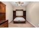 Bedroom with a built in wood Murphy bed deployed and flanked by shelves, wood floors and ceiling fan at 16538 E Westwind Ct # 51, Fountain Hills, AZ 85268