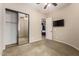 Bedroom with carpet, ceiling fan and a TV, with a slider closet and en-suite bathroom at 16538 E Westwind Ct # 51, Fountain Hills, AZ 85268