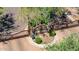 View of community entrance with stone monument, lush landscaping and paved road at 16538 E Westwind Ct # 51, Fountain Hills, AZ 85268
