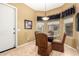 Cozy breakfast nook showcasing a round glass table, upholstered chairs, and a charming chandelier at 16538 E Westwind Ct # 51, Fountain Hills, AZ 85268