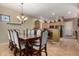 Elegant dining room with a large wooden table, seating for eight, and a decorative chandelier, open to the kitchen at 16538 E Westwind Ct # 51, Fountain Hills, AZ 85268