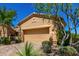 Image shows the garage with desert landscaping, pavers, and an artistic decorative touches at 16538 E Westwind Ct # 51, Fountain Hills, AZ 85268