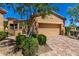 Exterior view of desert home, showcasing the garage, desert landscaping, and paved driveway at 16538 E Westwind Ct # 51, Fountain Hills, AZ 85268