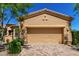 View of the garage, with its tan stucco and matching garage door, complementing the home's exterior at 16538 E Westwind Ct # 51, Fountain Hills, AZ 85268