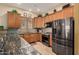 Well-equipped kitchen featuring stainless steel appliances, mosaic tile backsplash, and wood cabinetry at 16538 E Westwind Ct # 51, Fountain Hills, AZ 85268