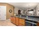 Open-concept kitchen area with granite countertops, wood cabinets, and a breakfast bar at 16538 E Westwind Ct # 51, Fountain Hills, AZ 85268