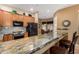 Modern kitchen with stainless steel appliances, granite countertops, and a breakfast bar with barstool seating at 16538 E Westwind Ct # 51, Fountain Hills, AZ 85268