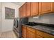 Laundry room with a large washer/dryer, built-in sink and storage cabinets at 16538 E Westwind Ct # 51, Fountain Hills, AZ 85268