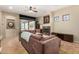 Living room features tile floors, fireplace, media center, and plush sofa with a serene outdoor view at 16538 E Westwind Ct # 51, Fountain Hills, AZ 85268