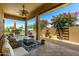 Spacious covered patio with a ceiling fan, comfortable seating, and a built-in outdoor grill at 16538 E Westwind Ct # 51, Fountain Hills, AZ 85268