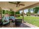 Backyard with a covered patio, outdoor seating, a ceiling fan, and well-maintained landscaping at 1705 W Lark Dr, Chandler, AZ 85286