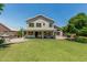 Expansive backyard featuring lush lawn, covered patio, and outdoor kitchen area perfect for entertaining at 1705 W Lark Dr, Chandler, AZ 85286