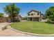 Spacious backyard with lush green grass, covered patio, outdoor kitchen and privacy wall at 1705 W Lark Dr, Chandler, AZ 85286