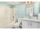 Bathroom with a shower-tub combination, a single sink vanity with white cabinets, and blue-green wall paint at 1705 W Lark Dr, Chandler, AZ 85286