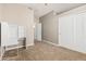 Carpeted bedroom featuring a desk, closet, and an open door leading to a bathroom at 1705 W Lark Dr, Chandler, AZ 85286