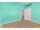 Carpeted bedroom featuring vibrant teal walls, white trim, closet, and an open doorway at 1705 W Lark Dr, Chandler, AZ 85286