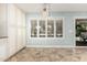 Inviting dining area featuring tile floors, plantation shutters, modern lighting, and a sliding glass door at 1705 W Lark Dr, Chandler, AZ 85286