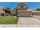 Beautiful two-story home with a spacious driveway, desert landscaping, and a tile roof at 1705 W Lark Dr, Chandler, AZ 85286