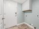 Laundry room features white cabinets, tile flooring, and hookups for a washer and dryer at 1705 W Lark Dr, Chandler, AZ 85286