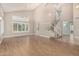 Spacious living room with wood floors, vaulted ceilings, large windows, and an open floor plan at 1705 W Lark Dr, Chandler, AZ 85286