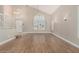 Bright living room with wood floors, vaulted ceilings, and large windows with plantation shutters at 1705 W Lark Dr, Chandler, AZ 85286