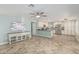 Spacious living area with tile floors, neutral tones, a ceiling fan, and an open kitchen concept at 1705 W Lark Dr, Chandler, AZ 85286