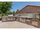 View of the stainless-steel outdoor kitchen on the patio with a built-in grill and brick pavers at 1705 W Lark Dr, Chandler, AZ 85286